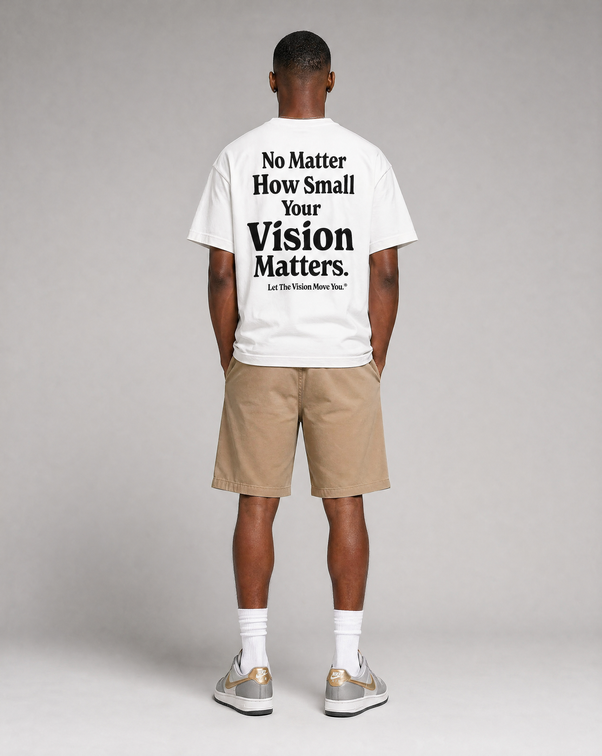 Person wearing a white t-shirt with motivational text on the back, standing against a plain background.